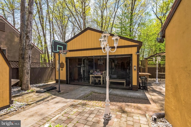 exterior space featuring fence and an outdoor structure