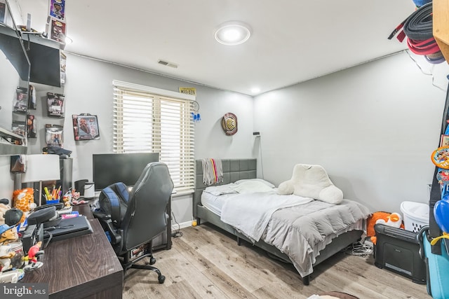 bedroom with visible vents and wood finished floors