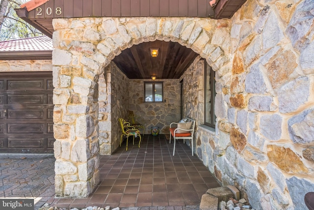 property entrance featuring stone siding