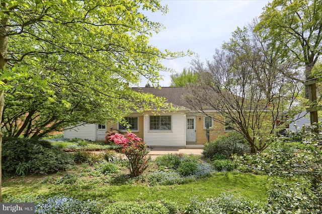 exterior space featuring roof with shingles