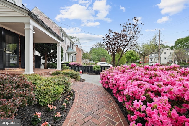 view of yard featuring a porch and fence