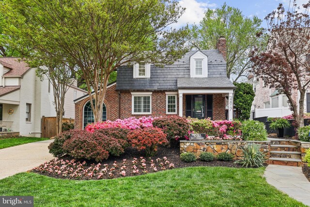 4817 Chevy Chase Blvd, Chevy Chase, MD 20815 - view of front facade featuring a chimney, brick siding, and a high end roof