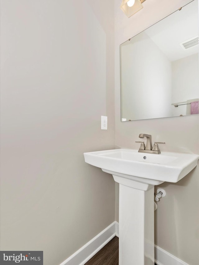 5303 Crape Myrtle Dr, Frederick, MD 21703 - bathroom with baseboards, wood finished floors, and a sink
