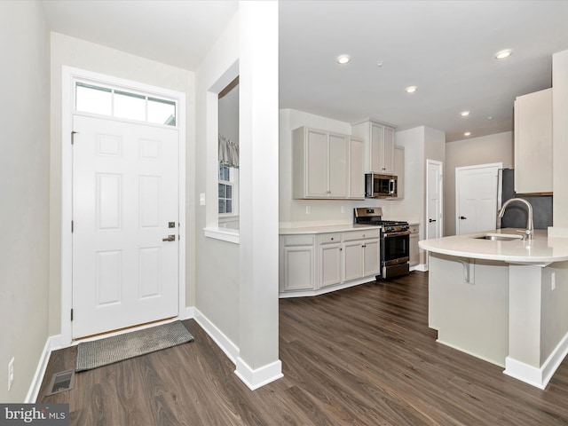 5303 Crape Myrtle Dr, Frederick, MD 21703 - kitchen with appliances with stainless steel finishes, a sink, dark wood-type flooring, baseboards, and recessed lighting