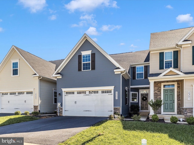 5303 Crape Myrtle Dr, Frederick, MD 21703 - view of front facade with stone siding, asphalt driveway, a front lawn, and a garage