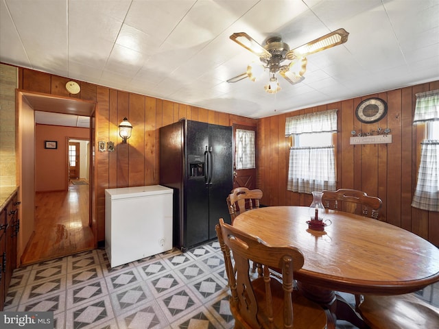 62 N 4th St, Chambersburg, PA 17201 - dining area featuring light floors, ceiling fan, and wood walls