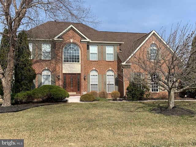 345 Jessica Dr, Middletown, DE 19709 - view of front of property with brick siding, a shingled roof, and a front yard