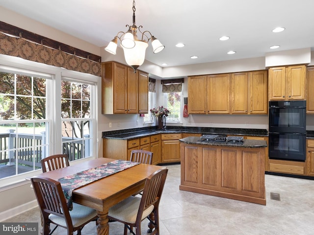 345 Jessica Dr, Middletown, DE 19709 - kitchen with visible vents, a kitchen island, recessed lighting, brown cabinets, and black appliances
