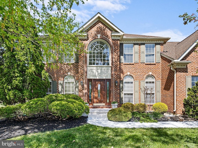 345 Jessica Dr, Middletown, DE 19709 - georgian-style home featuring brick siding, roof with shingles, and a front yard