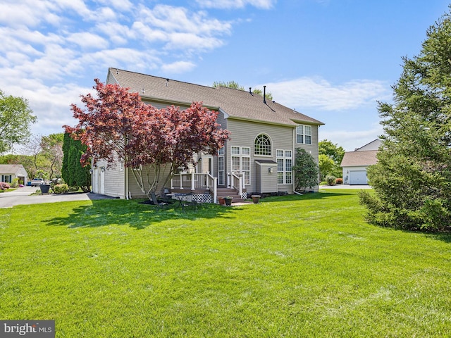 345 Jessica Dr, Middletown, DE 19709 - back of house featuring a lawn, aphalt driveway, and a garage