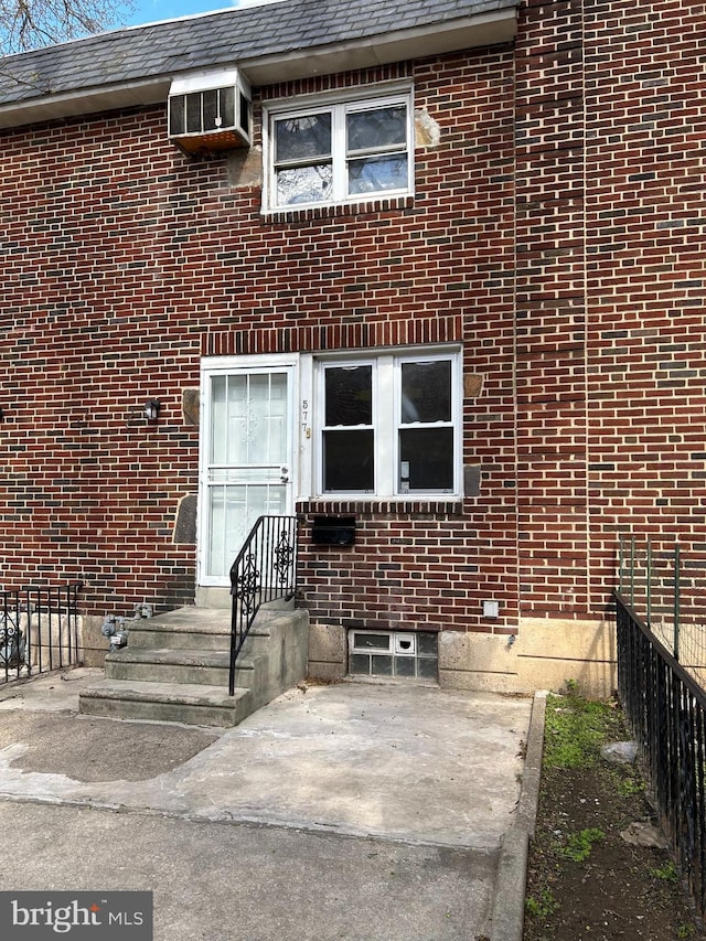 577 Snowden Rd, Upper Darby, PA 19082 - property entrance with fence, a patio area, and brick siding