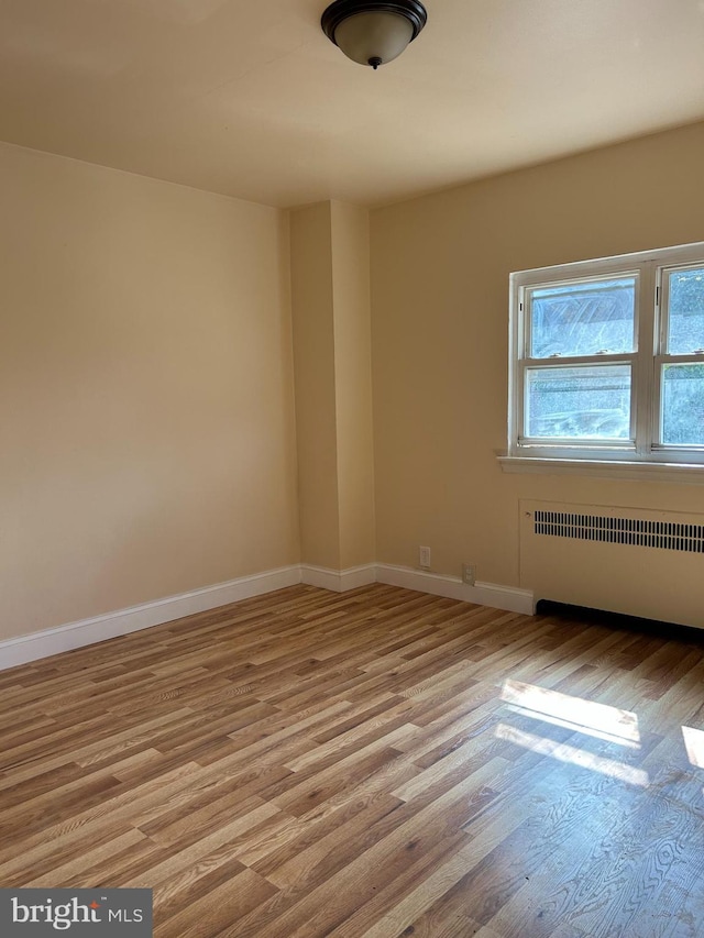 577 Snowden Rd, Upper Darby, PA 19082 - empty room with radiator, baseboards, and light wood-type flooring