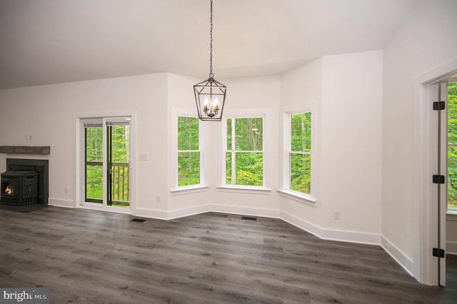 9343 Troy Dr, Nokesville, VA 20181 - unfurnished dining area with baseboards, a notable chandelier, dark wood finished floors, and a wood stove