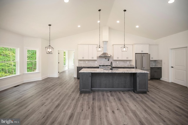 9343 Troy Dr, Nokesville, VA 20181 - kitchen featuring backsplash, white cabinetry, a large island with sink, and high end refrigerator