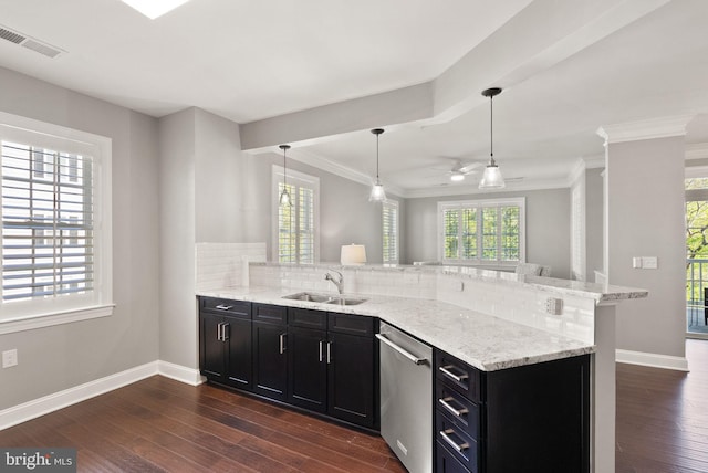 kitchen featuring stainless steel dishwasher, decorative backsplash, a peninsula, dark cabinets, and a sink
