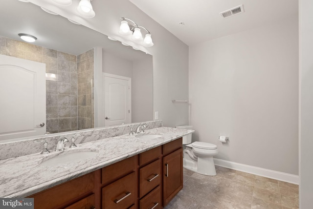 full bathroom featuring double vanity, baseboards, visible vents, and a sink