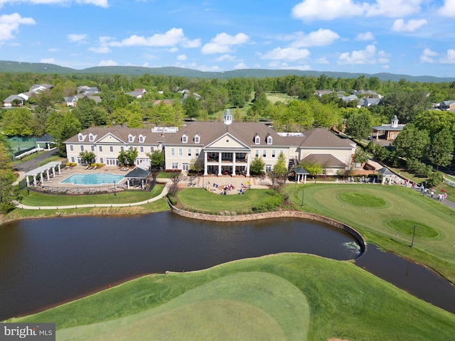 aerial view featuring a residential view, golf course view, and a water and mountain view