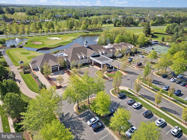 drone / aerial view with a water view, view of golf course, and a residential view