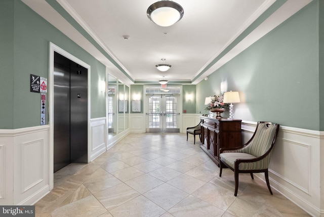 corridor featuring french doors, ornamental molding, a decorative wall, and elevator