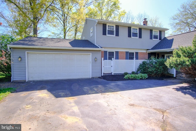 view of front facade featuring a garage, fence, driveway, and a chimney