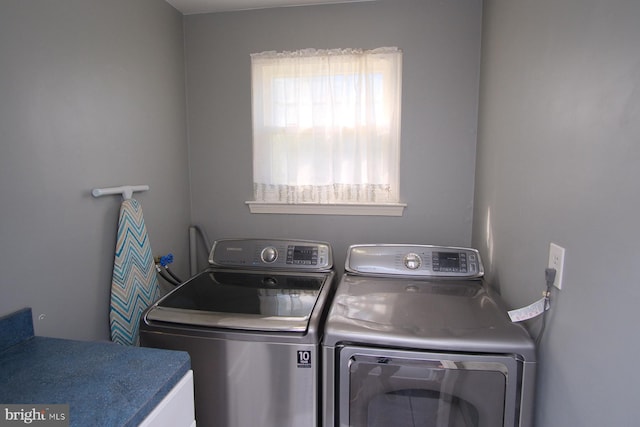clothes washing area featuring washer and dryer and laundry area