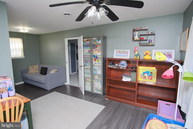 playroom with visible vents, baseboards, ceiling fan, and wood finished floors