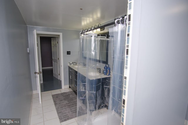 bathroom featuring vanity, baseboards, and a stall shower