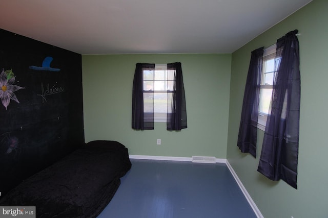sitting room with baseboards, a wealth of natural light, and visible vents