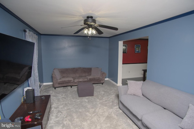 living area featuring crown molding, ceiling fan, carpet floors, and baseboards