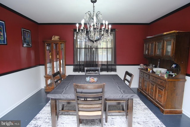 dining space featuring baseboards, ornamental molding, and a chandelier