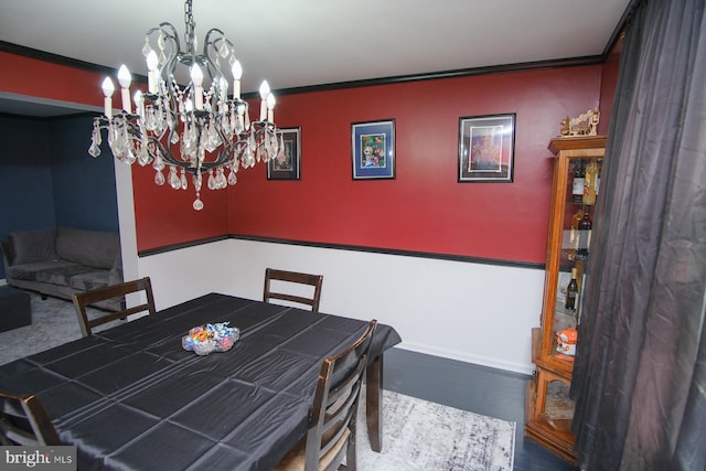dining area with an inviting chandelier and crown molding