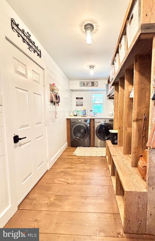 laundry area featuring independent washer and dryer and light wood-style flooring