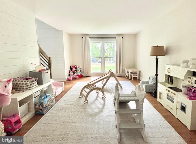 playroom featuring dark wood-style floors