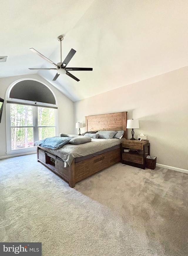 carpeted bedroom featuring lofted ceiling, baseboards, and ceiling fan