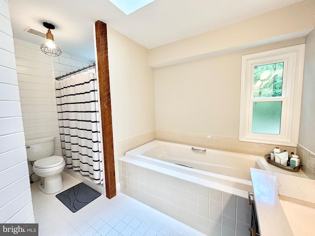 bathroom featuring toilet, a bath, tile patterned floors, a shower with curtain, and a skylight