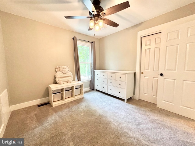 carpeted bedroom with baseboards, a ceiling fan, and a closet