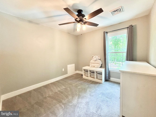 empty room with baseboards, ceiling fan, and carpet flooring