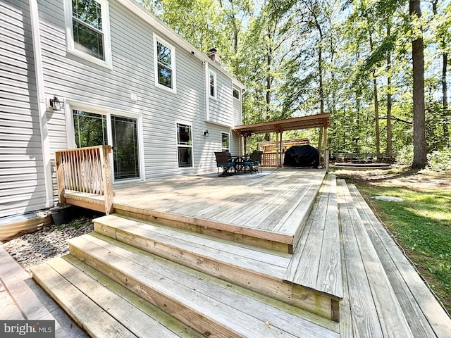 wooden terrace with outdoor dining area
