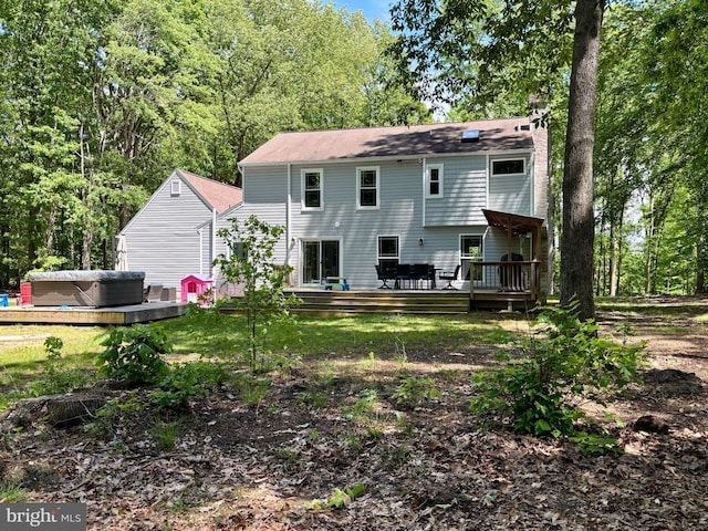 rear view of house with a wooden deck and a chimney