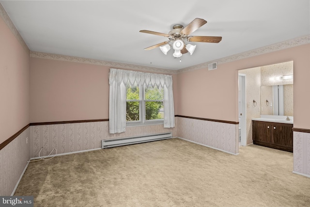 48 Dunstable Rd, Southampton, NJ 08088 - empty room featuring baseboard heating, wainscoting, ceiling fan, carpet flooring, and a sink