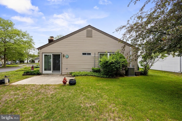 48 Dunstable Rd, Southampton, NJ 08088 - back of property with a lawn, a patio, a chimney, and cooling unit