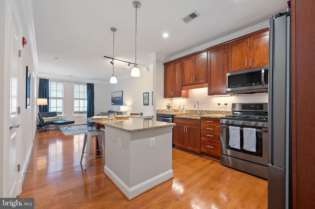 1023 N Royal St Unit 104, Alexandria, VA 22314 - kitchen with appliances with stainless steel finishes, open floor plan, light wood-style floors, crown molding, and recessed lighting
