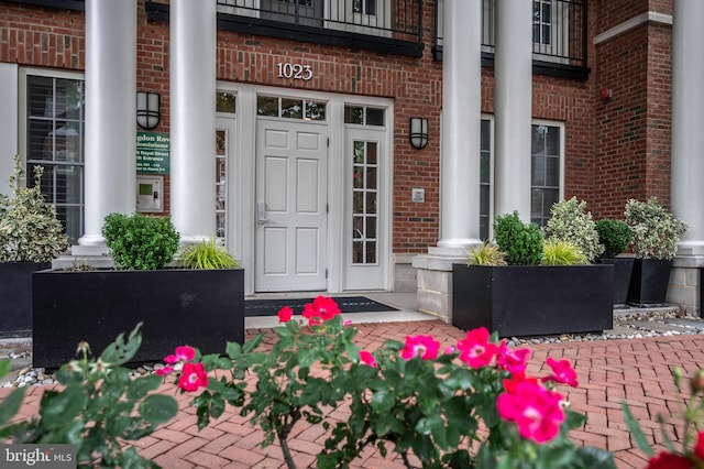 1023 N Royal St Unit 104, Alexandria, VA 22314 - doorway to property featuring brick siding and a porch