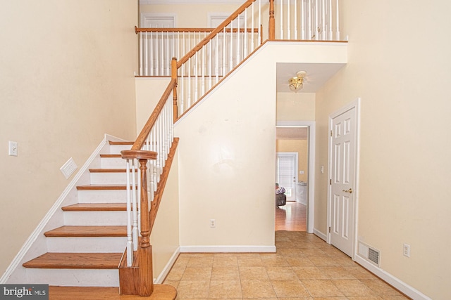 105 Fairfield Dr, Winchester, VA 22602 - stairway featuring a high ceiling, baseboards, and tile patterned flooring