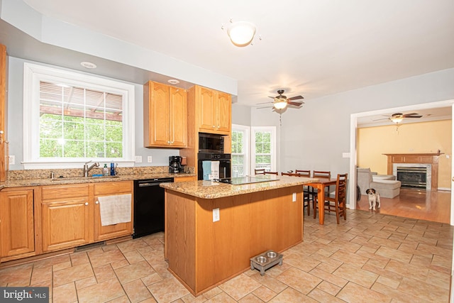 105 Fairfield Dr, Winchester, VA 22602 - kitchen featuring black appliances, a sink, a ceiling fan, a kitchen island, and light stone finish floors