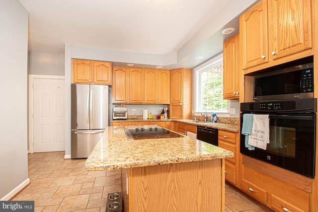 105 Fairfield Dr, Winchester, VA 22602 - kitchen featuring black appliances, light stone counters, baseboards, a kitchen island, and a kitchen breakfast bar