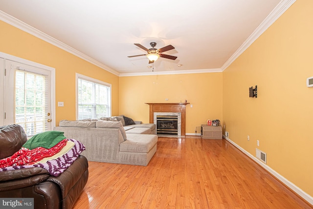 105 Fairfield Dr, Winchester, VA 22602 - living area with light wood finished floors, crown molding, a ceiling fan, a premium fireplace, and baseboards