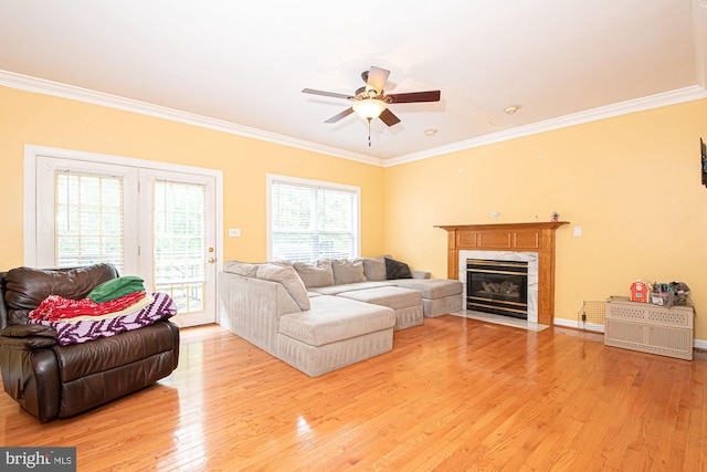 105 Fairfield Dr, Winchester, VA 22602 - living area with crown molding, light wood-type flooring, ceiling fan, and a premium fireplace