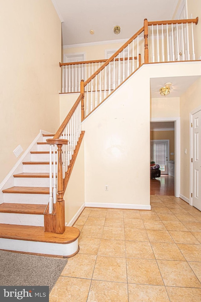 105 Fairfield Dr, Winchester, VA 22602 - staircase featuring tile patterned flooring, baseboards, a high ceiling, and crown molding