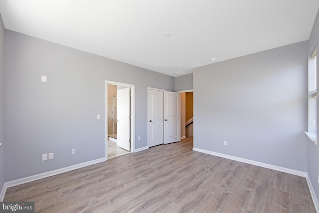 unfurnished bedroom featuring baseboards and light wood-style flooring